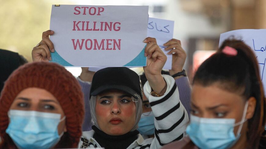 Iraqi women's rights activists lift placards during a rally near the Supreme Judicial Council in Baghdad on Feb. 5.