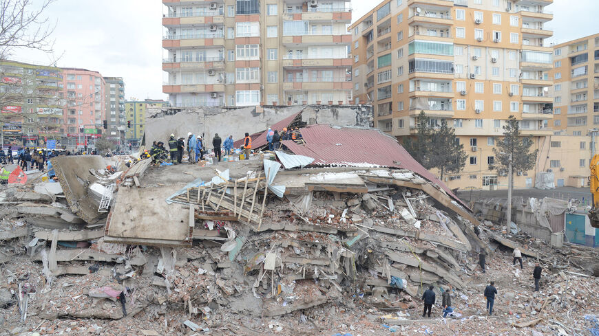 Rescue workers and volunteers conduct search and rescue operations in the rubble of a collapsed building, in Diyarbakir, Turkey, on February 6, 2023