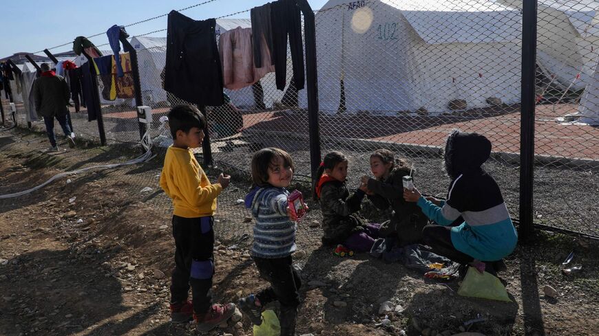 Quake-hit displaced children play near tents set by Turkey's Disaster and Emergency Management Presidency (AFAD) at Islahiye Atatürk Stadium in Islahiye near Gaziantep on Feb. 14, 2023, a week after a deadly earthquake struck parts of Turkey and Syria. 