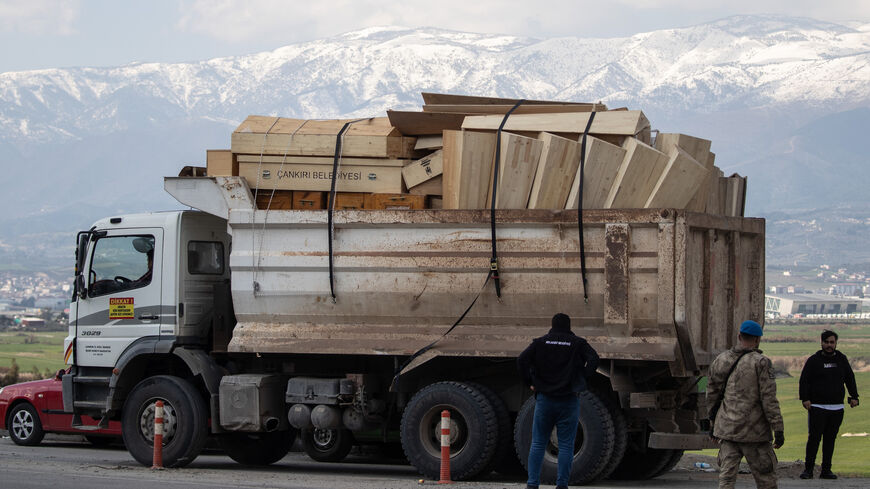 A truck carries empty coffins to the cemetery on Feb. 10, 2023, in Hatay, Turkey.