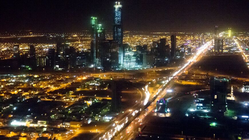 The skyline of Riyadh, Saudi Arabia, March 28, 2014, is seen at night in this aerial photograph from a helicopter. AFP PHOTO / Saul LOEB (Photo credit should read SAUL LOEB/AFP via Getty Images)