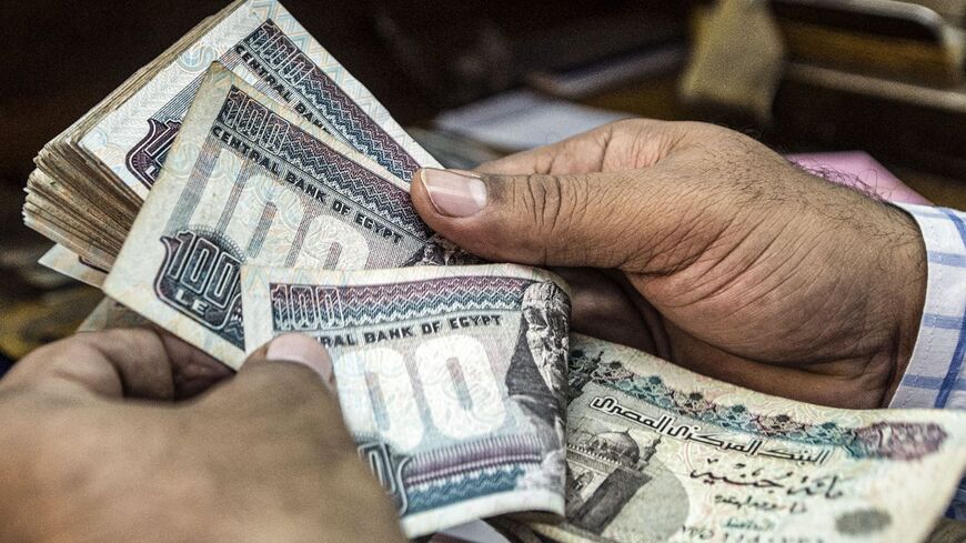 A man counts Egyptian pounds at a currency exchange shop in downtown Cairo on Nov. 3, 2016.