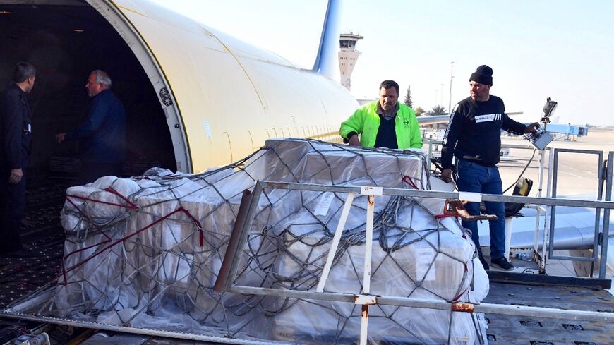 Boxes of foreign aid arrive at Damascus international airport two weeks after a deadly earthquake