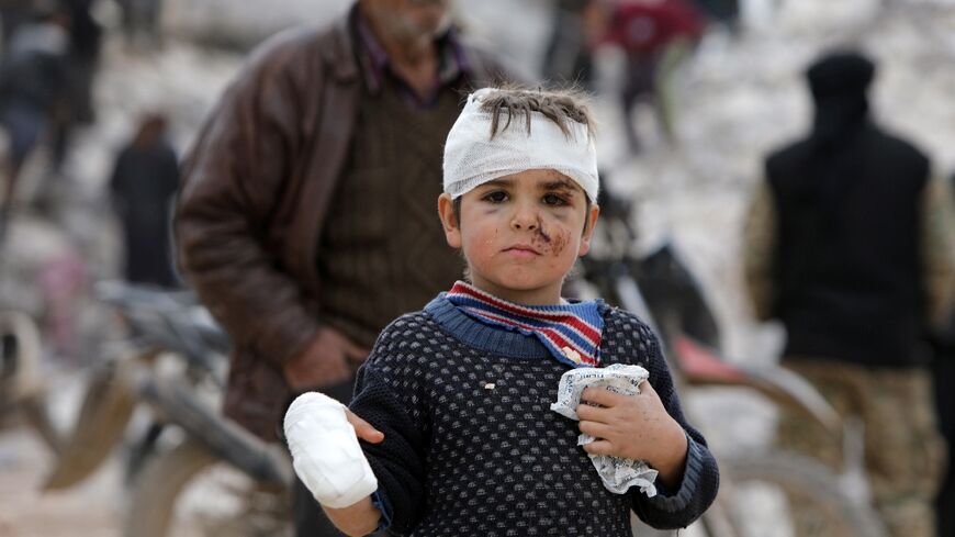 Six-year-old Musa Hmeidi shows off his bandages after being pulled alive from the rubble of the family home in the rebel-held Syrian town of Jindayris