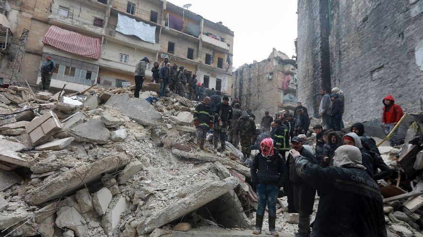 Syrian rescue teams search for victims and survivors at the rubble a collapsed building in the city of Aleppo