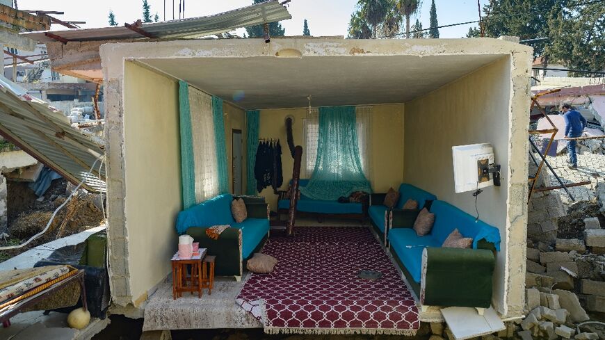 A living room appears intact but is now one floor lower in devastated Demirkopru, a Turkish village torn apart by a deadly earthquake