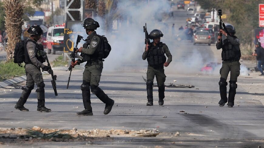 Israeli soldiers clash with Palestinian youths during the raid in Jericho
