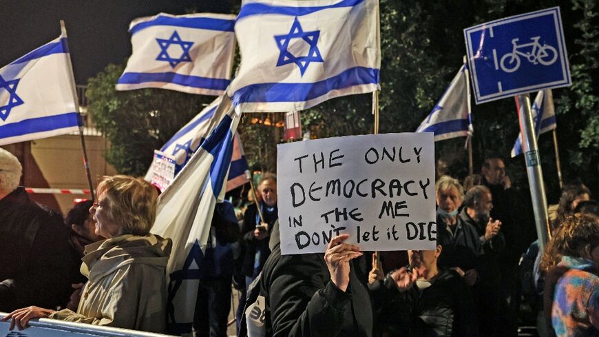Opponents of the government's judicial reforms demonstrate outside the Israeli president's residence, the venue for the talks with opposition party representatives