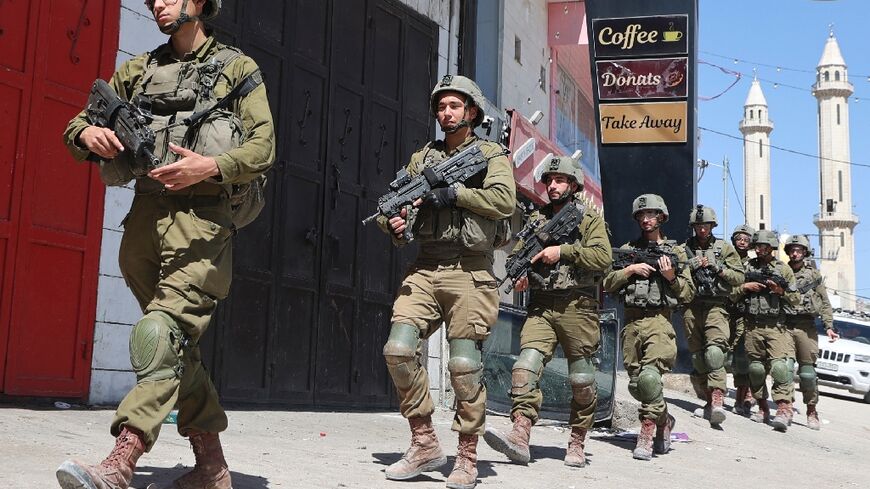 Israeli troops patrol in the occupied-West Bank town of Huwara 