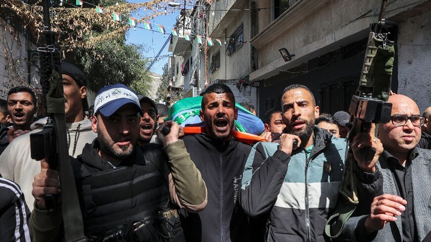 Palestinian mourners march in the funeral of Hamas fighter Abdel Fatah Hussein Khroushah, who who was killed the previous day in the occupied West Bank during fighting in an Israeli raid