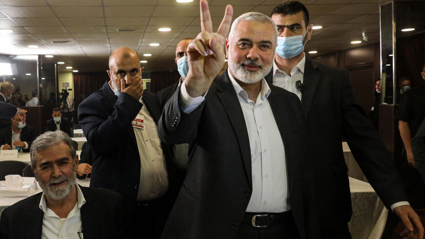 Hamas chief Ismail Haniyeh (front) flashes the victory gesture upon arriving for a meeting with representatives of other Palestinian factions at the Palestinian embassy in Lebanon's capital Beirut on September 3, 2020, in rare talks on how to respond to such accords and to a Middle East peace plan announced by Washington this year. - The meeting in Beirut is joined by video conference with talks in Ramallah between Palestinian president Mahmud Abbas and representatives of Palestinian factions there. Haniyeh