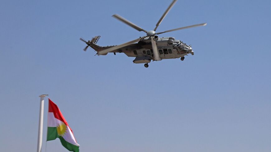 An AS332 Super Puma military helicopter flies during a graduation ceremony for Iraqi Kurdish Peshmerga officers in Arbil, the capital of Iraq's northern autonomous Kurdish region, on June 21, 2021. 