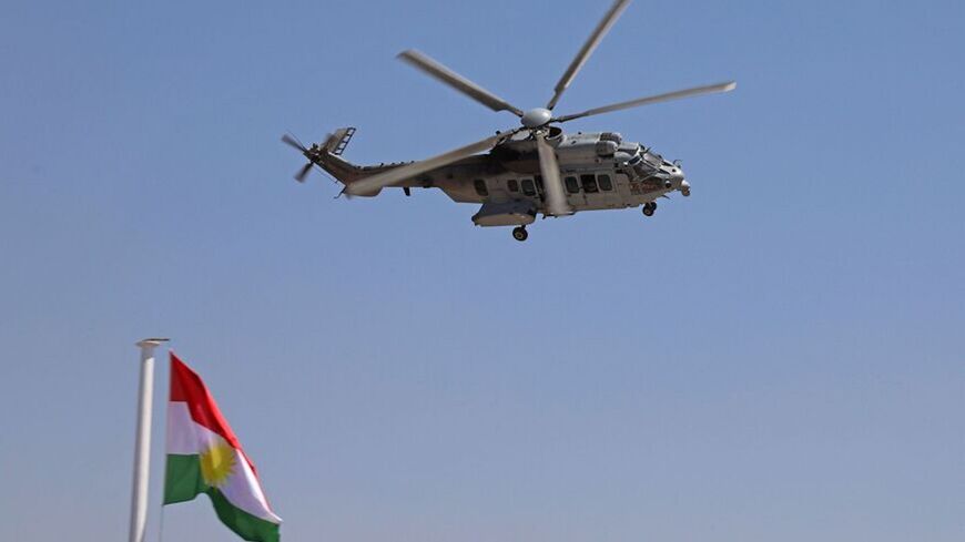 An AS332 Super Puma military helicopter flies during a graduation ceremony for Iraqi Kurdish Peshmerga officers.