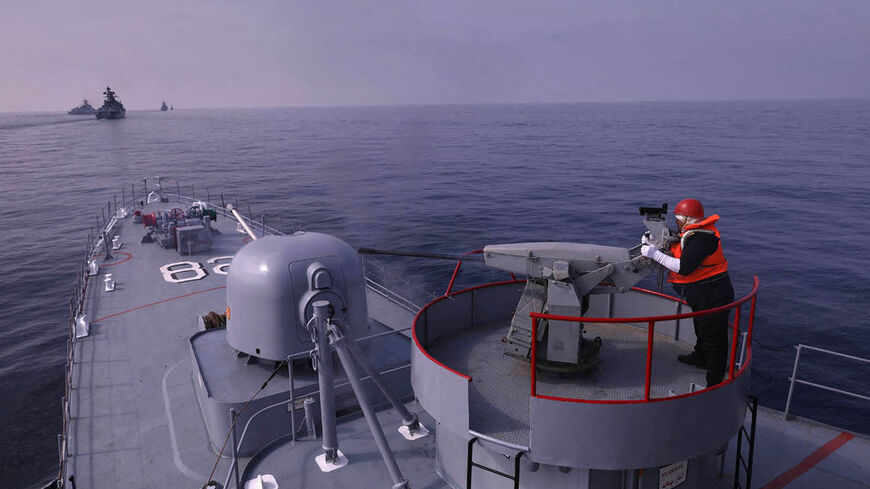 A handout picture made available by the Iranian Army official website on January, 21 2022 shows an navy-man firing atop a warship during a joint military drill in the Indian ocean. - Iran, Russia and China will began today joint naval drills for three days in the Indian Ocean, seeking to reinforce "common security", an Iranian naval official said. (Photo by Iranian Army office / AFP) (Photo by -/Iranian Army office/AFP via Getty Images)
