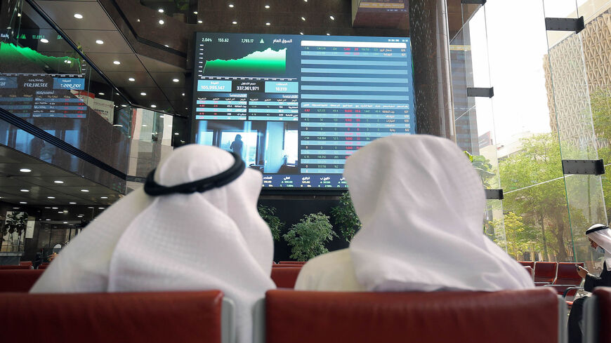 Traders follow the movement of stock prices at the Kuwait Stock Exchange, Kuwait City, March 2, 2022.