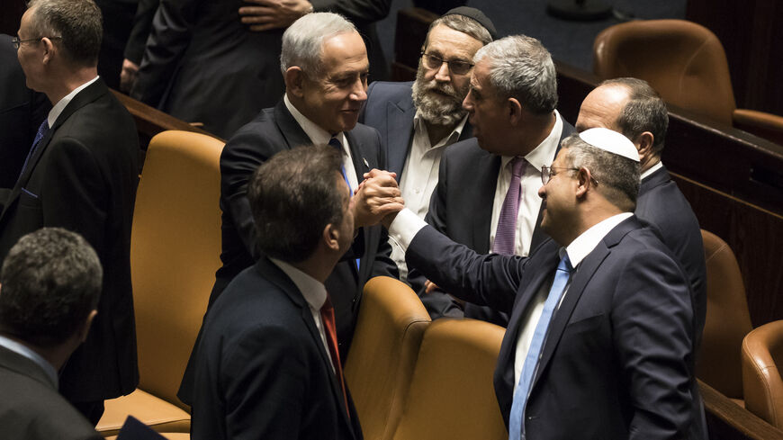  Israeli Prime Minister Benjamin Netanyahu and Minister of National Security Itamar Ben Gvir react after sworn in at the Israeli parliament during a new government sworn in discussion at the Israeli parliament on December 29, 2022