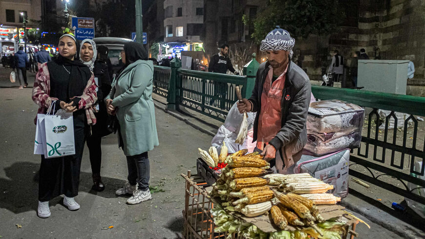 A pedlar sells roasted corn cobs by the medieval Sultan al-Ghuri Complex (built in 1505) in Azhar district, Cairo, Egypt, Jan. 16, 2023.