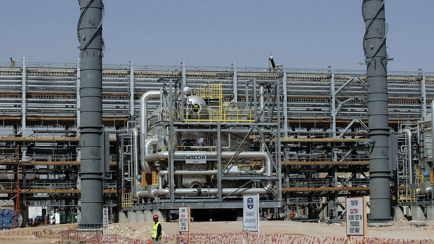 Asian labourers work at the construction site of Saudi Aramco's (the national oil company) Al-Khurais central oil processing facility in the Saudi Arabian desert, 160 kms east of the capital Riyadh, on June 23, 2008. Deep in the Saudi desert, 28,000 Asian workers are racing to get a giant oil processing complex ready to help King Abdullah keep a vow to meet world demand for crude. AFP PHOTO/MARWAN NAAMANI (Photo by MARWAN NAAMANI / AFP) (Photo by MARWAN NAAMANI/AFP via Getty Images)
