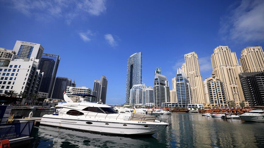 Boats are anchored in the Dubai Creek surrounded by high-rise buildings in the Gult emirate, on February 18, 2023. - Home to towering skyscrapers and ultra-luxury villas, Dubai saw record real estate transactions in 2022, largely due to an influx of wealthy investors, especially from Russia. (Photo by KARIM SAHIB/AFP via Getty Images)