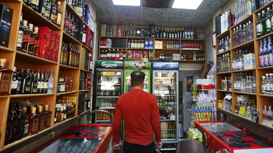A man walks inside a liquor shop in Baghdad on February 23, 2023.  (Photo by MURTAJA LATEEF/AFP via Getty Images)