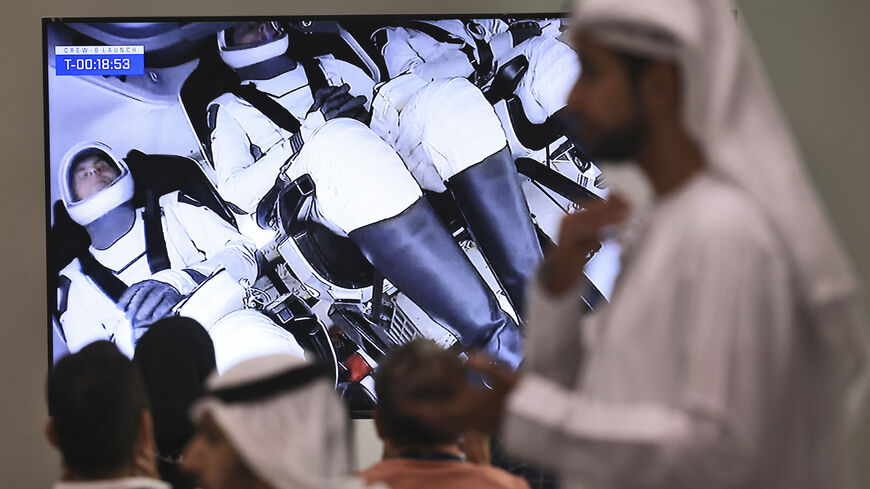 People watch the lauching of NASA and SpaceX Dragon Crew-6 mission to International Space Station, at the Mohammed bin Rashid Space Centre (MBRSC) in Dubai on March 2, 2023. - A SpaceX Falcon 9 rocket blasted off to the International Space Station carrying two NASA astronauts, a Russian cosmonaut and the second Emirati to voyage to space. (Photo by KARIM SAHIB/AFP via Getty Images)