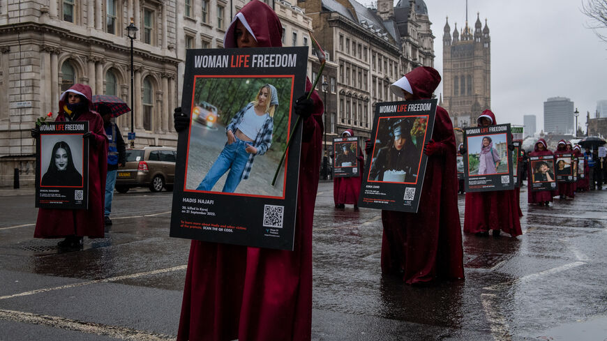 Iranian Women in handmaiden costumes march along Whitehall as a peaceful protest for womens rights on International Womens Day on March 8, 2023 in London, England. Protests continue internationally in solidarity with Iranian women in their struggle for full gender equality and to have the freedom to choose how they want to dress and live their lives without fear, assault or intimidation. (Photo by Chris J Ratcliffe/Getty Images)