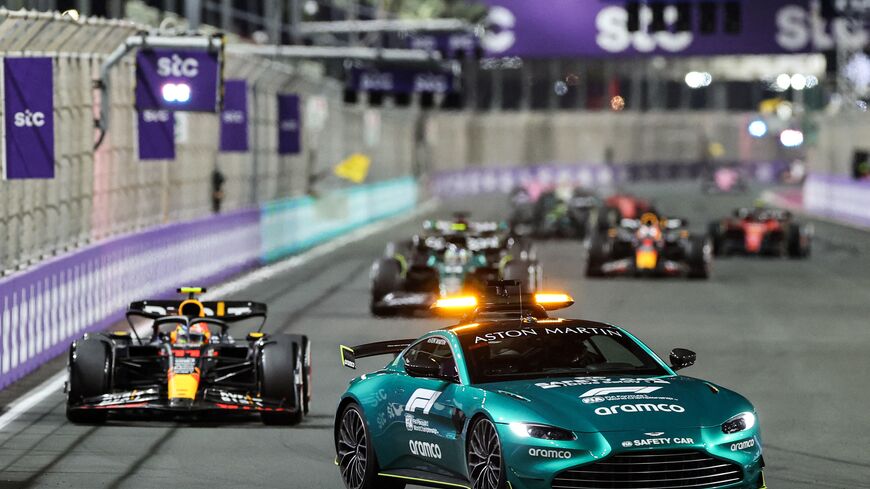 The safety car drives in front of Red Bull Racing's Mexican driver Sergio Perez (L) during the Saudi Arabia Formula One Grand Prix at the Jeddah Corniche Circuit in Jeddah on March 19, 2023. (Photo by GIUSEPPE CACACE/AFP via Getty Images)