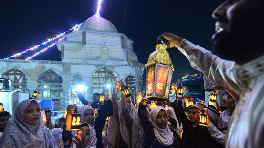 Iraqi children carry Ramadan lanterns.