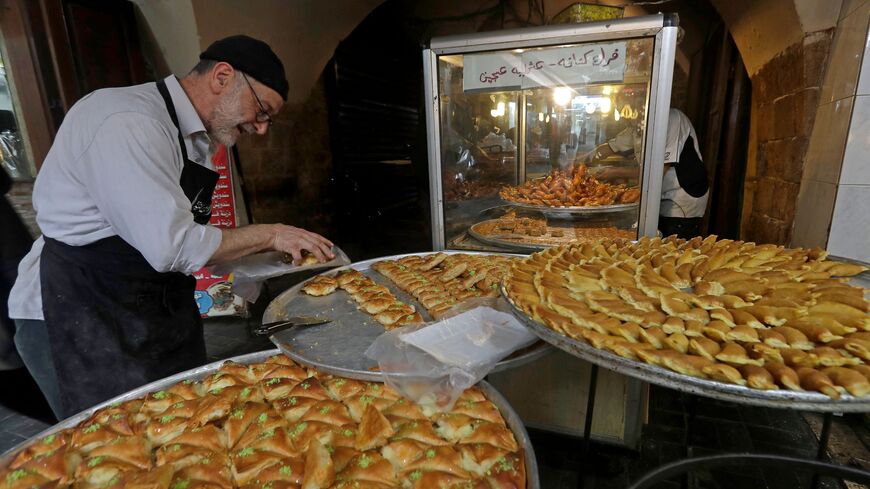 A vendor sells traditional sweets at a market in the southern city of Sidon (Saida) on March 23, 2023 as Muslim devotees shop during the holy fasting month of Ramadan. (Photo by Mahmoud ZAYYAT / AFP) (Photo by MAHMOUD ZAYYAT/AFP via Getty Images)