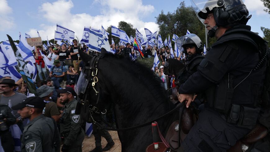 Mounted Israeli police stand guard as protesters gather outside Israel's parliament in Jerusalem amid ongoing demonstrations and calls for a general strike against the hard-right government's controversial push to overhaul the justice system, on March 27, 2023. (Photo by HAZEM BADER / AFP) (Photo by HAZEM BADER/AFP via Getty Images)
