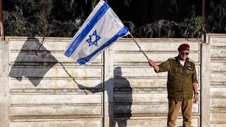 Ghiora Lehler, a 79-year-old veteran Israeli paratrooper, waves a national flag during a rally against the government's judicial reform bill.