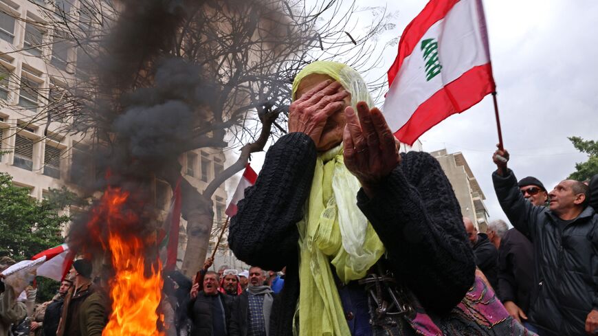 A woman reacts as retired servicemen protest to demand inflation-adjustments to their pensions outside Lebanon's central bank headquarters in Beirut on March 30, 2023. (Photo by JOSEPH EID / AFP) (Photo by JOSEPH EID/AFP via Getty Images)