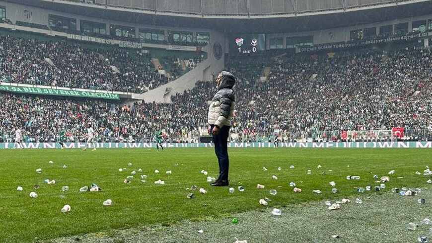 Water bottles, knives and other objects are thrown on the pitch in the Bursa Timsah Arena in Turkey.