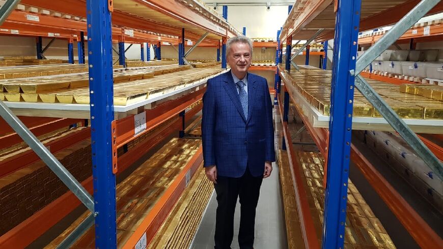 Lebanon's central bank governor Riad Salameh stands next to stacks of gold bars in the bank vaults in the Lebanese capital Beirut on November 24, 2022