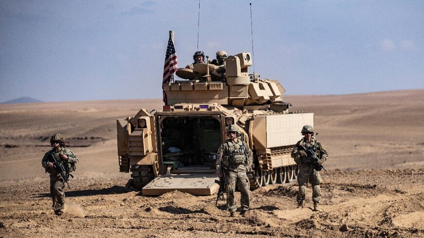 Troops from the Syrian Democratic Forces (SDF) and the US-led anti-jihadist coalition, take part in exercises in Syria near Deir Ezzor on March 25, 2022