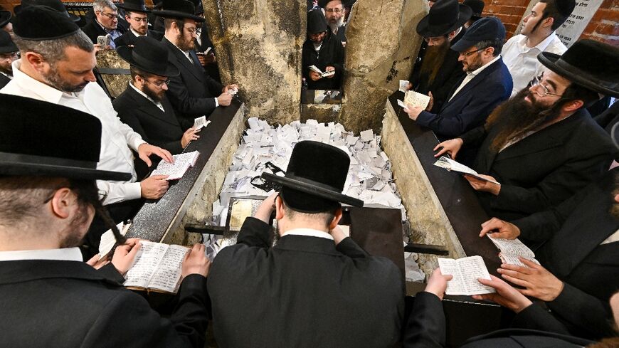 Hasidic Jewish pilgrims pray around the tomb of  'Miracle Rabbi' Yeshaya Steiner