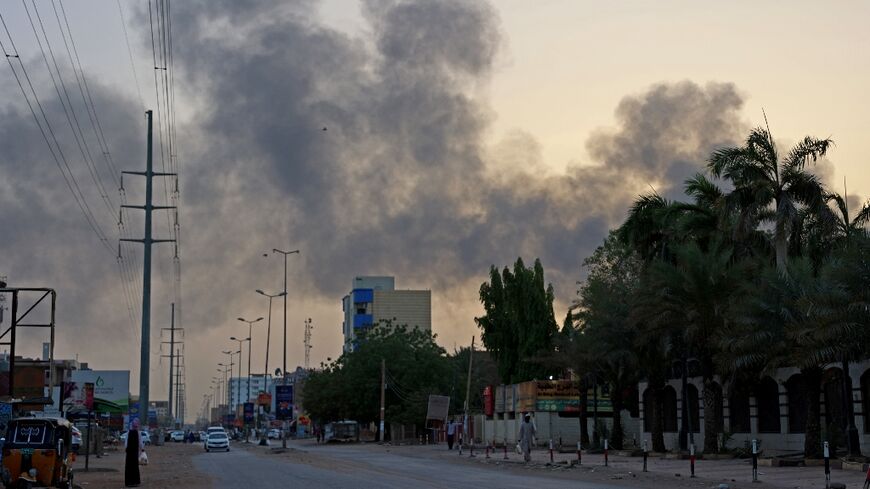 Smoke billows above residential buildings in east Khartoum as fighting in Sudan raged for a second day
