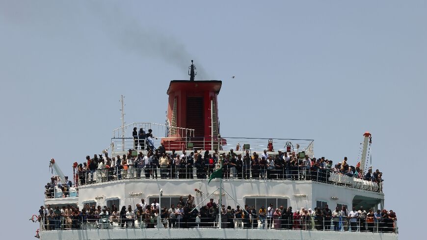 A ferry transporting about 1,900 people arrives at Saudi Arabia's King Faisal Naval base in Jeddah after crossing the Red Sea from Port Sudan with people who fled the fighting