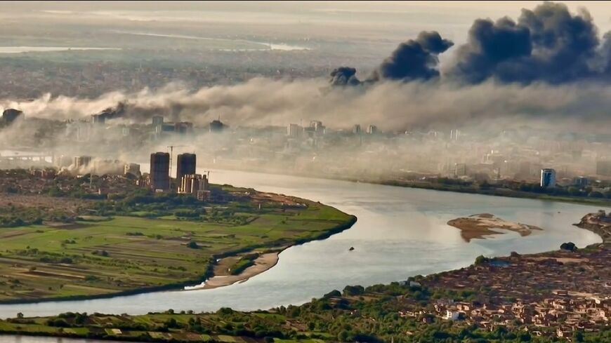 This video grab taken from AFPTV video footage on April 19, 2023, shows an aerial view of black smoke covering the sky above the capital Khartoum
