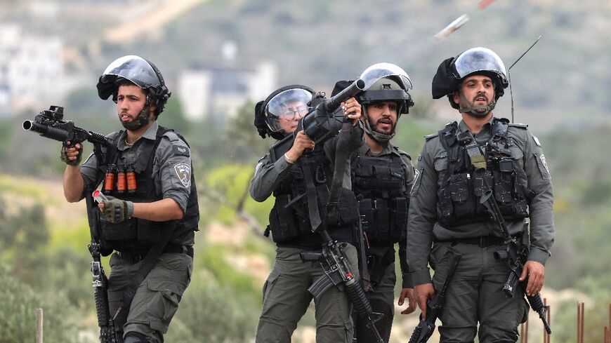 Israeli security forces fire tear gas at Palestinians, in Beita village of the occupied West Bank, demonstrating against a nearby march by Jewish settlers 