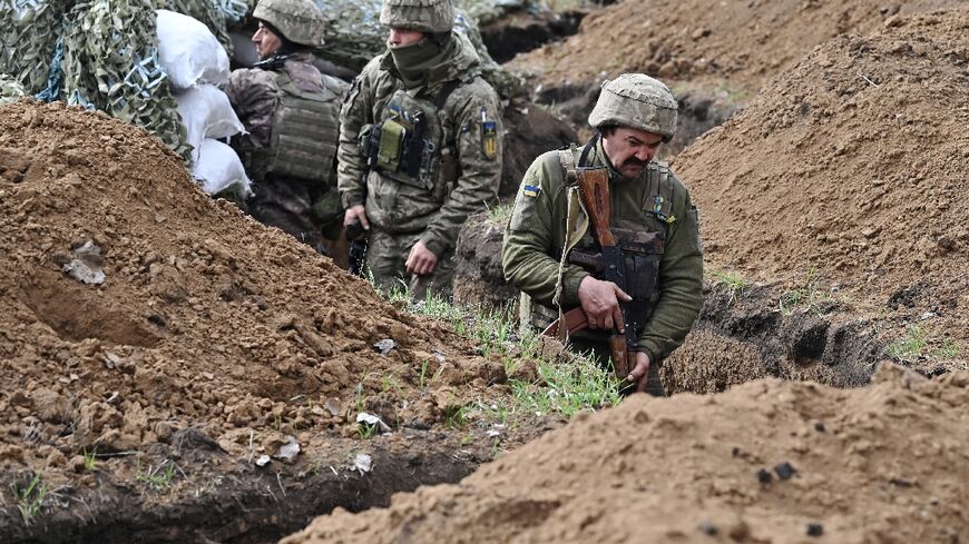 Ukrainian troops in a trench near near the battleground city of Bakhmut on April 8, 2023