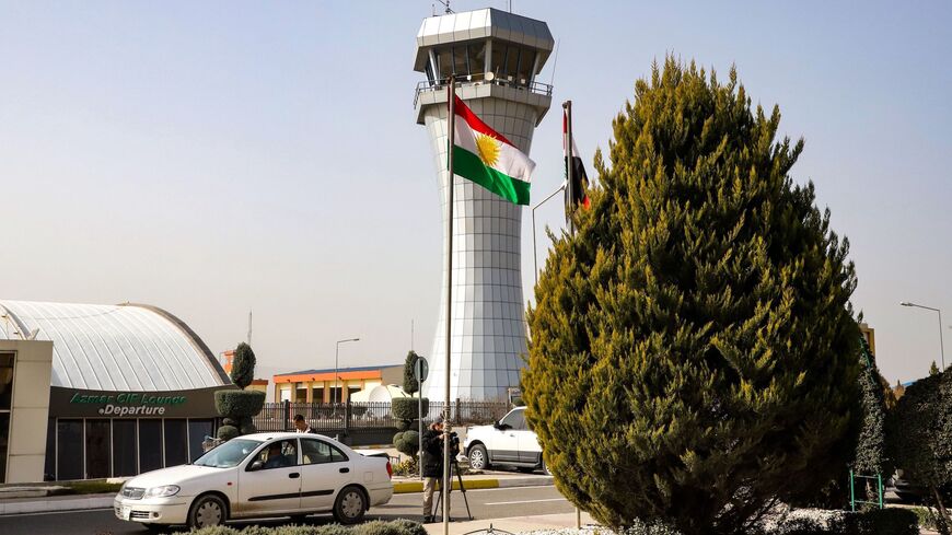 This picture taken on Jan. 26, 2019, shows journalists filming outside the departure lounge and control tower of Sulaimaniyah International Airport. 