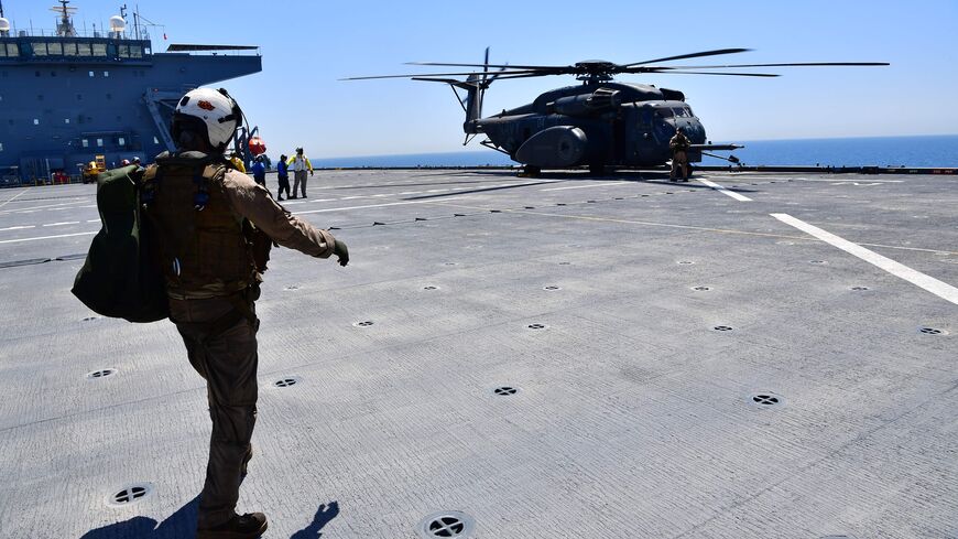 A flight specialist walks towards an MH-53E Sea Dragon on the deck of the Lewis B. Puller carrier during a joint demining drill between the US, British and French Navy in the Arabian Gulf on April 15, 2019. - The US, French and British navies have launched anti-mine exercises off Bahrain in support of the free movement of trade in Gulf waters, a military spokeswoman said Monday. (Photo by Giuseppe CACACE / AFP) (Photo credit should read GIUSEPPE CACACE/AFP via Getty Images)
