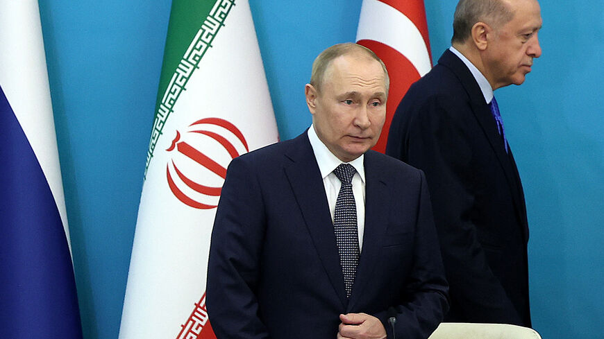 Russian President Vladimir Putin and Turkish President Recep Tayyip Erdogan (R) arrive for a joint press conference with their Iranian counterpart following their summit in Tehran on July 19, 2022. (Photo by ATTA KENARE / AFP) (Photo by ATTA KENARE/AFP via Getty Images)