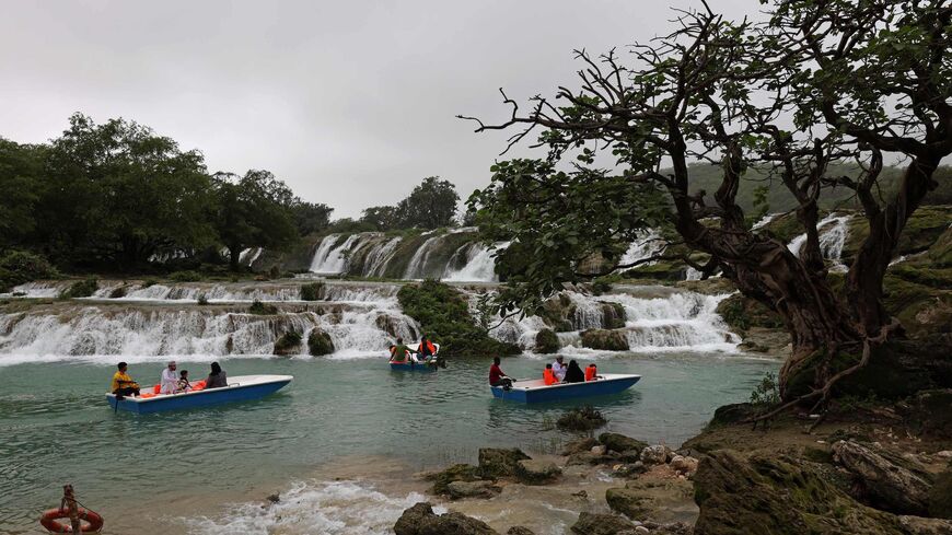 Locals and tourists ride in speed boats at the Wadi Darbat (Darbat Valley) near Salalah, in the southern Omani province of Dhofar on July 21, 2022. (Photo by Mohammed MAHJOUB / AFP) (Photo by MOHAMMED MAHJOUB/AFP via Getty Images)