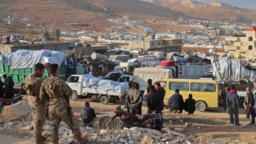 Syrian refugees prepare to leave Lebanon toward Syrian territory.