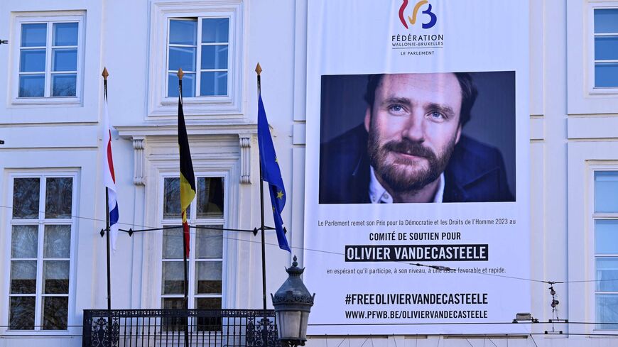 This photograph taken on Feb. 8, 2023, shows a large banner with a portrait of Belgian aid worker Olivier Vandecasteele.
