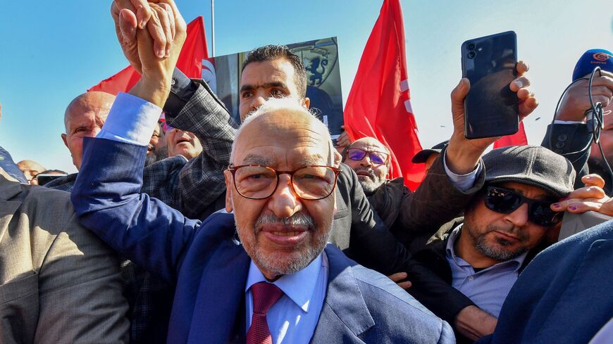The head of Tunisia's Islamist movement Ennahdha Rached Ghannouchi greets supporters upon arrival to a police station in Tunis on Feb. 21, 2023, in compliance to the summons of an investigating judge.