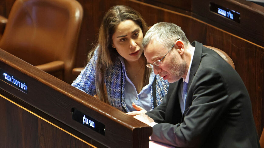 Israeli Justice Minister Yariv Levin (R) listens to MP May Golan during a session at the Knesset, Jerusalem, March 20, 2023.