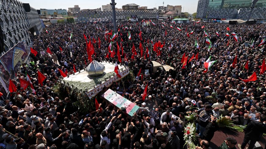 Mourners attend the funeral procession for two of Iran's revolutionary guard forces killed by Israel in Syria, held in Tehran on April 4, 2023. - The two Iranian fighters, identified as Milad Heidari and Meghdad Mahghani, were killed on March 31, 2023 when Israel launched several missiles from the occupied Golan Heights against pro-regime positions near Damascus. (Photo by ATTA KENARE / AFP) (Photo by ATTA KENARE/AFP via Getty Images)